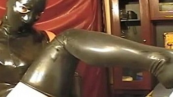 Girl in latex tight dress and mask on webcam