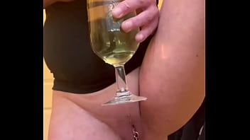 Filled up two glasses by my strong stream pee and next put in my mouth and spitting on my big tits