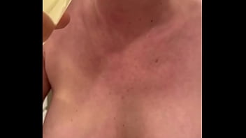 Filled up two glasses by my strong stream pee and next put in my mouth and spitting on my big tits