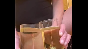 Filled up two glasses by my strong stream pee and next put in my mouth and spitting on my big tits