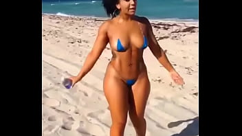 Sexy latina in mini bikini on the beach