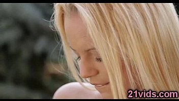 Cute blonde plays in garden