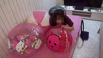 Japanese girl deflating the beachballs