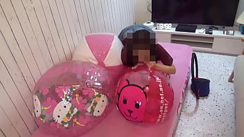 Japanese girl deflating the beachballs