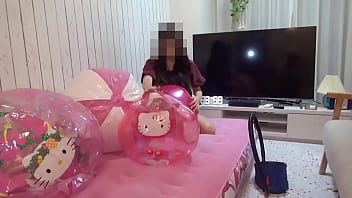 Japanese girl deflating the beachballs Japanese girl deflating the beachballs