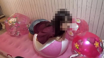 Japanese girl deflating the beachballs