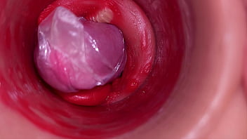 The camera inside the deep pussy records a huge ejaculation with a stuck condom