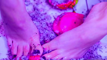 Bare toes crushing juicy fruit