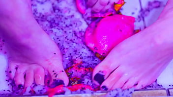 Bare toes crushing juicy fruit