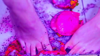 Bare toes crushing juicy fruit