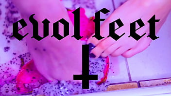 Bare toes crushing juicy fruit