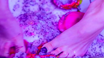 Bare toes crushing juicy fruit