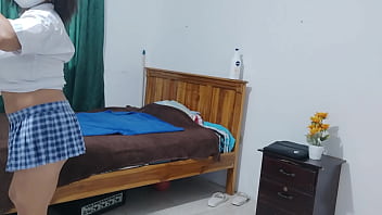 A female student in a dress dresses in her apartment she's a friendly humble busty woman