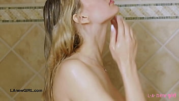 Striking blonde bombshell enjoys a sensual bath