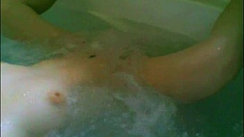 Solo female in whirlpool bathtub