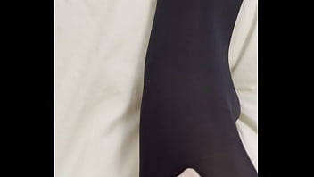 Boy rubs my feet in my new stockings