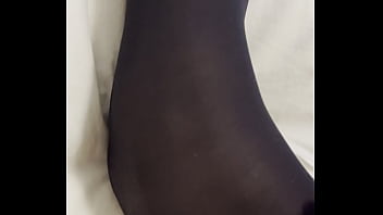 Boy rubs my feet in my new stockings