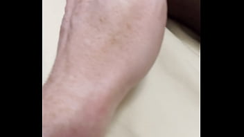 Boy rubs my feet in my new stockings