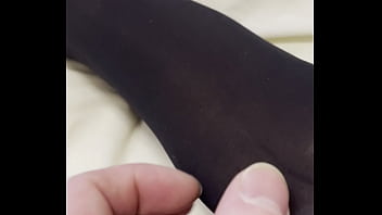 Boy rubs my feet in my new stockings