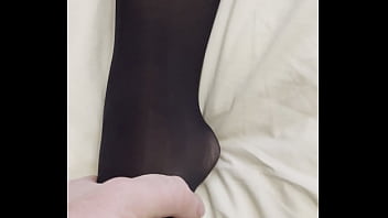 Boy rubs my feet in my new stockings