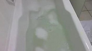Big titted latina plays with her toy in soapy bathtub