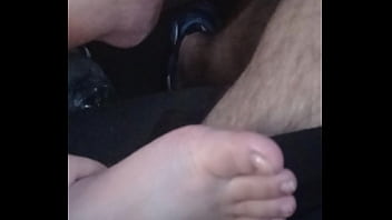 She plays with my dick with feet