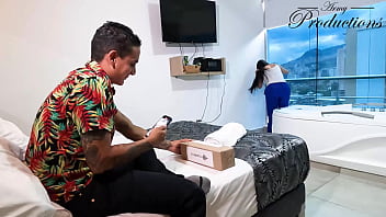 The cleaning girl helps him with his new toy by sucking him