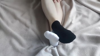 Mismatched black and white ankle socks for a sensual sockjob
