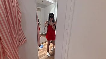 Camera in a public fitting room nice brunette tries on underwear