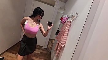 Camera in a public fitting room nice brunette tries on underwear