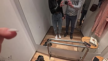 Camera in a public fitting room nice brunette tries on underwear