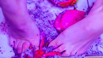 Bare toes crushing juicy fruit