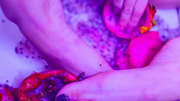 Bare toes crushing juicy fruit