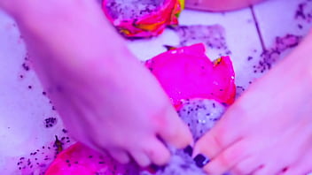 Bare toes crushing juicy fruit