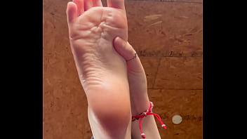 White girl takes socks off and puts lotion on her soft and clean feet