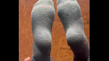 White girl takes socks off and puts lotion on her soft and clean feet