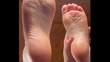 White girl takes socks off and puts lotion on her soft and clean feet