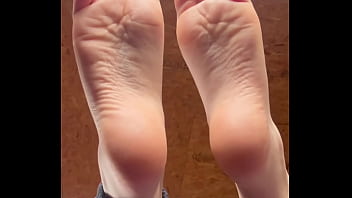 White girl takes socks off and puts lotion on her soft and clean feet