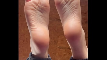 White girl takes socks off and puts lotion on her soft and clean feet