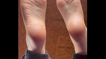 White girl takes socks off and puts lotion on her soft and clean feet