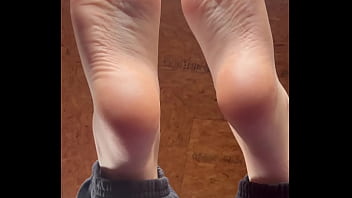 White girl takes socks off and puts lotion on her soft and clean feet