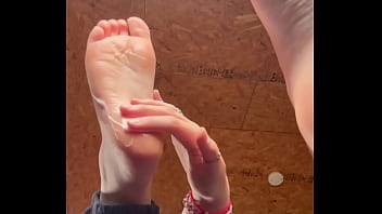 White girl takes socks off and puts lotion on her soft and clean feet