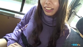 A woman in the rear seat of a vehicle engaged in oral sex with a large penis