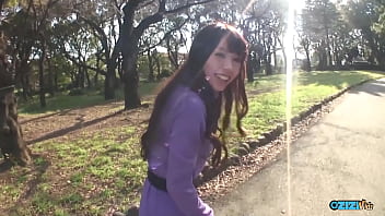 A woman in the rear seat of a vehicle engaged in oral sex with a large penis