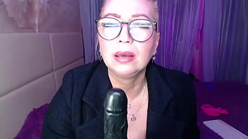 A cool busty vulgar mature whore in glasses with a ponytail on her head