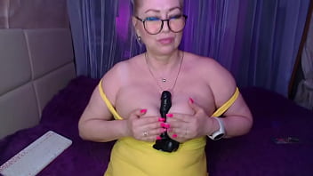 A cool busty vulgar mature whore in glasses with a ponytail on her head