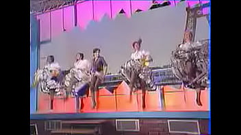 Girls dance and kick on stage showing upskirts