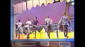 Girls dance and kick on stage showing upskirts