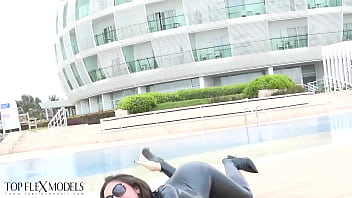 Flexible miss in a black latex catsuit
