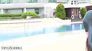 Flexible miss in a black latex catsuit